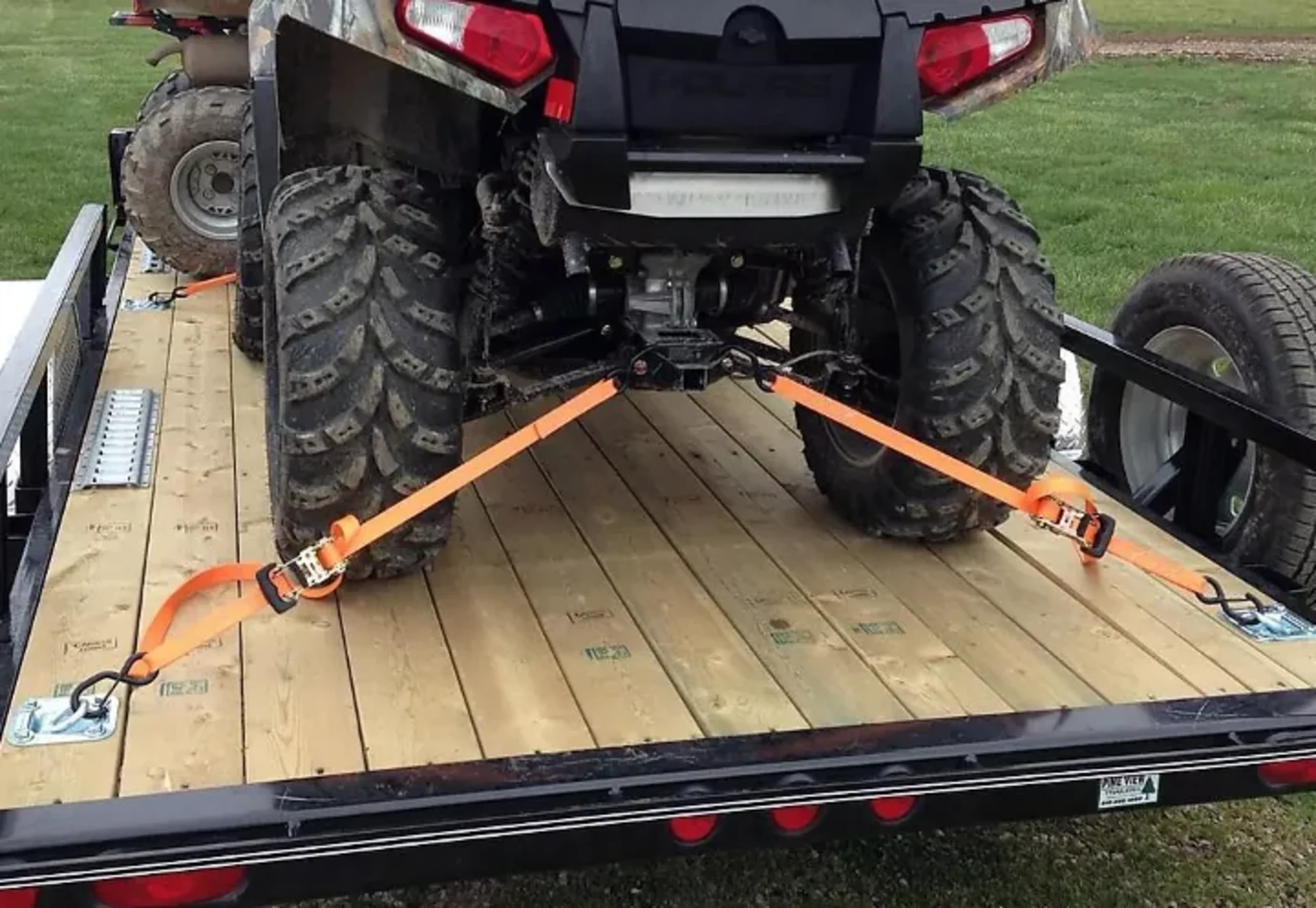 UTV on a trailer using the X-cross strapping method.png