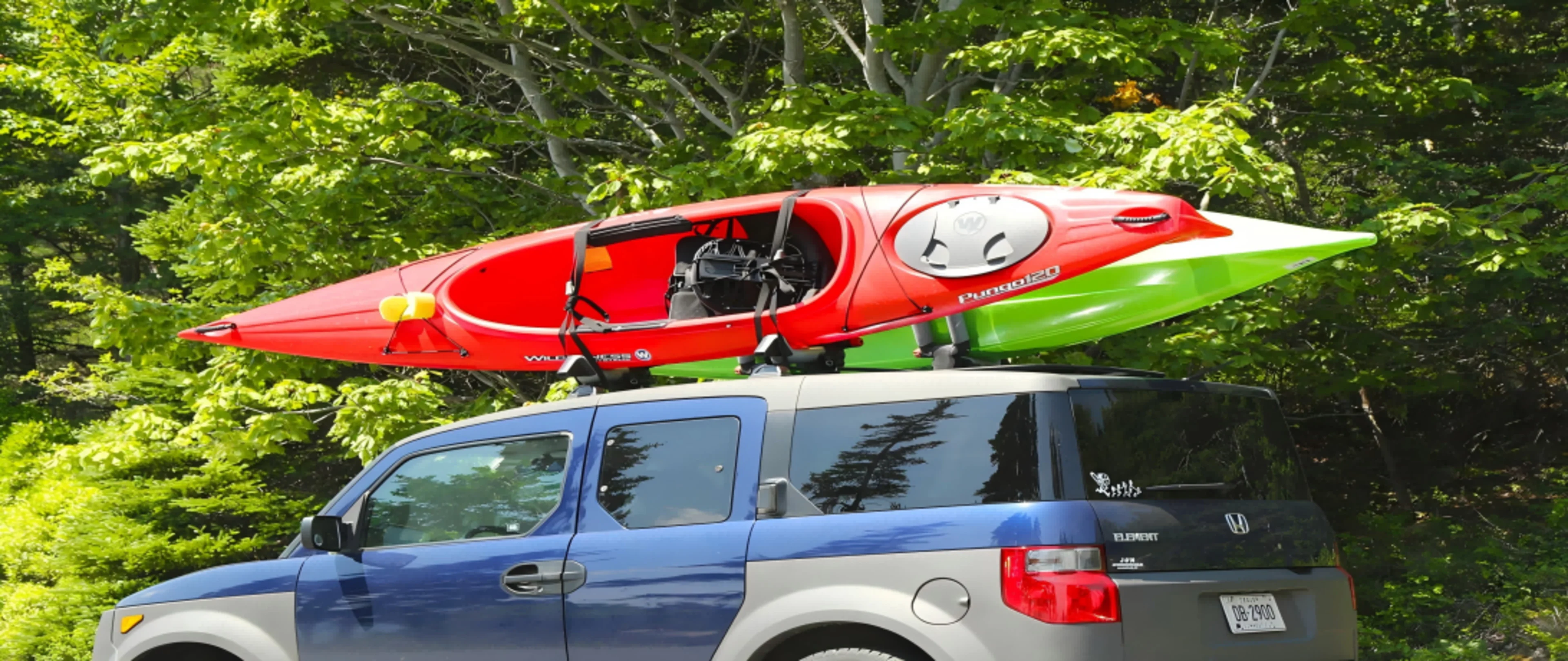 kayak secured to a roof rack with a stainless steel buckle strap.png